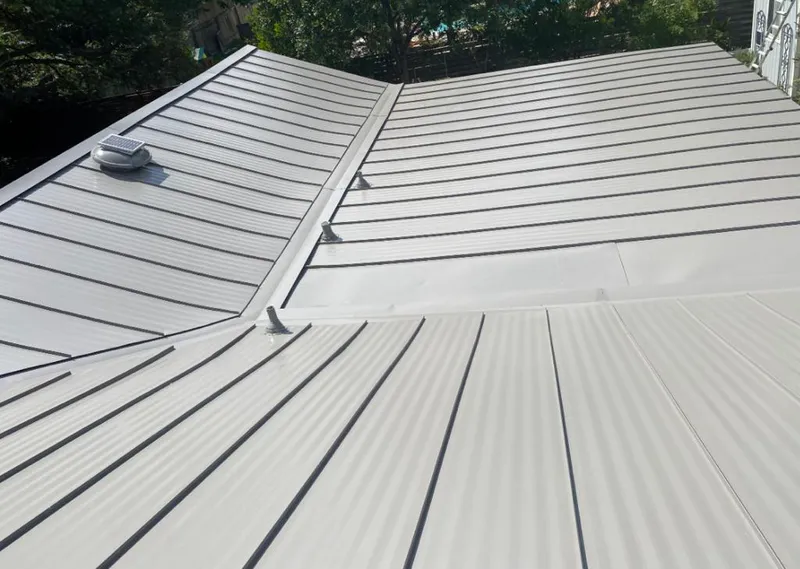 Solar attic fan installed on a metal roof for Roof Ventilation in Forest Park